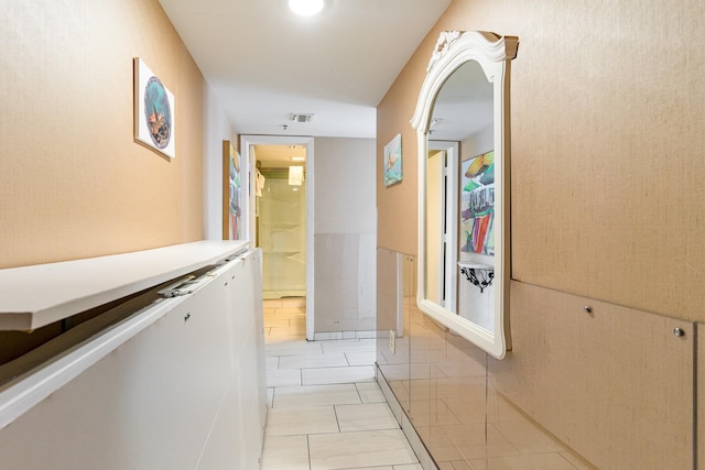 corridor featuring light tile patterned floors