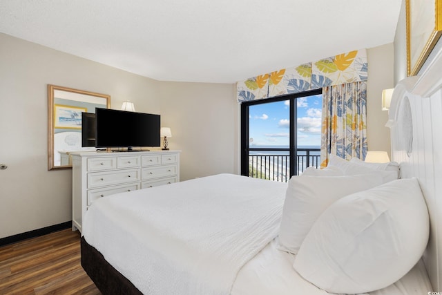 bedroom with dark hardwood / wood-style floors and access to outside