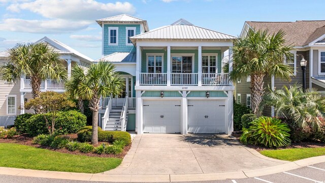 coastal inspired home featuring a balcony and a garage