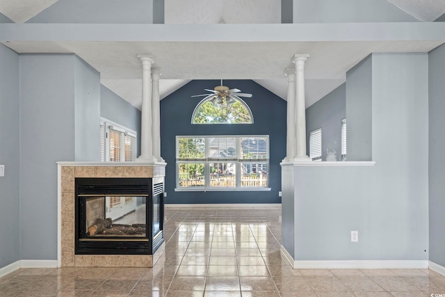 tiled living room featuring ornate columns, lofted ceiling, a fireplace, and ceiling fan