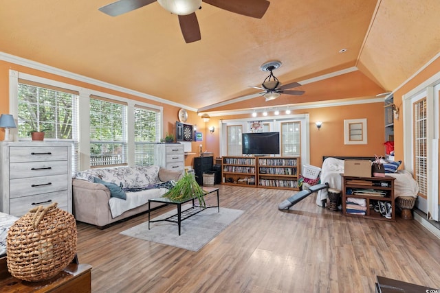 living room with lofted ceiling, ornamental molding, and wood-type flooring