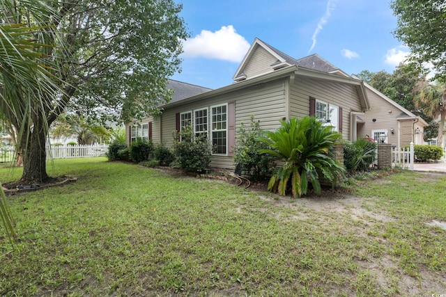 view of property exterior with a yard