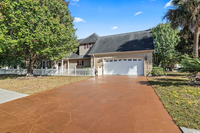 view of front of home featuring a front yard and a garage