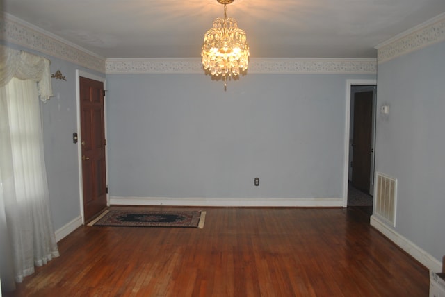 unfurnished room featuring ornamental molding, a chandelier, and wood-type flooring