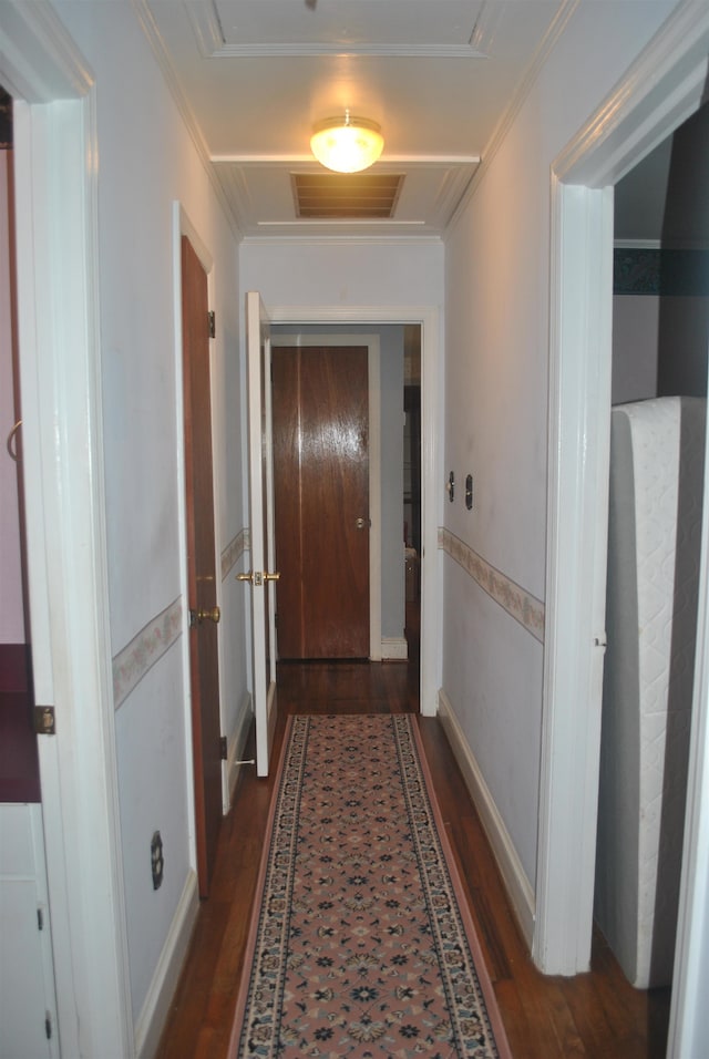 hall with dark hardwood / wood-style flooring and ornamental molding