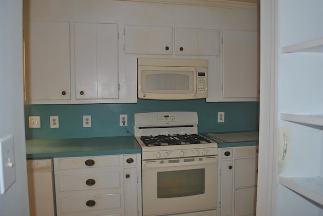 kitchen with white appliances and white cabinetry