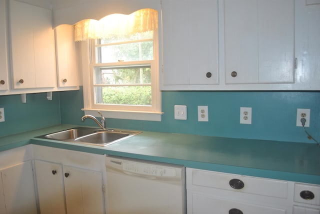 kitchen featuring sink, white cabinetry, and white dishwasher