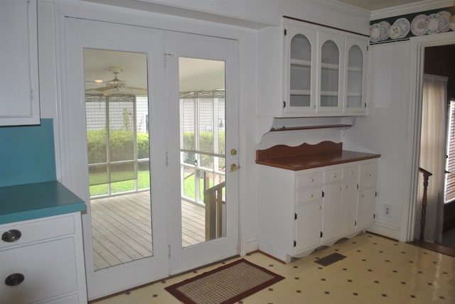 kitchen featuring plenty of natural light, ceiling fan, white cabinetry, and light tile patterned floors