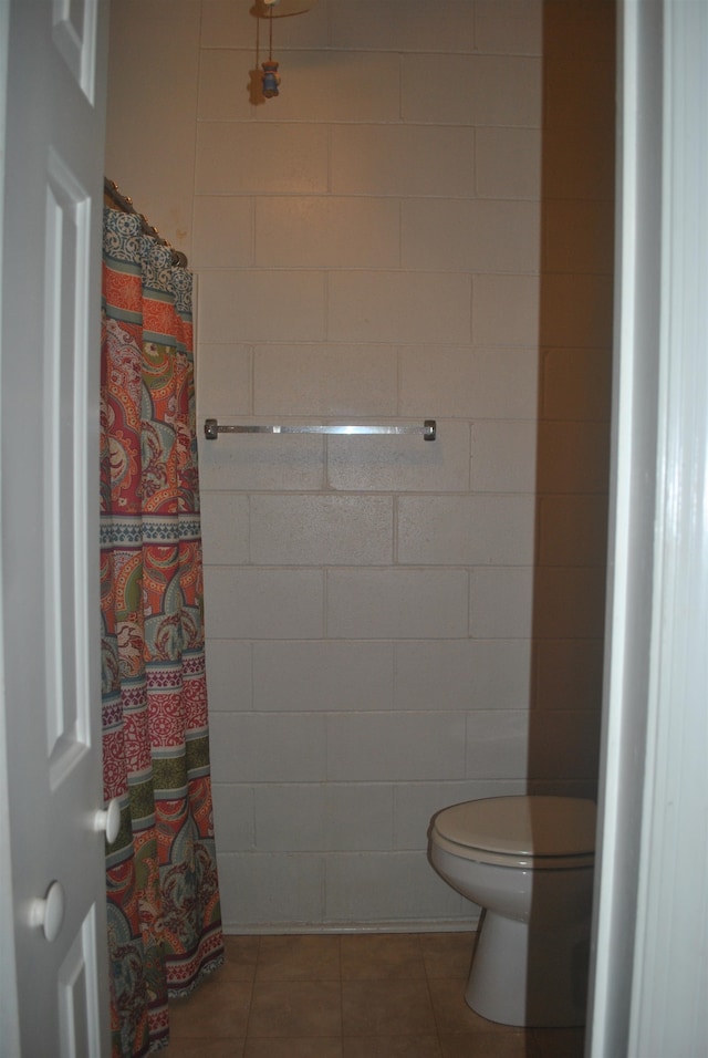 bathroom featuring toilet and tile patterned flooring