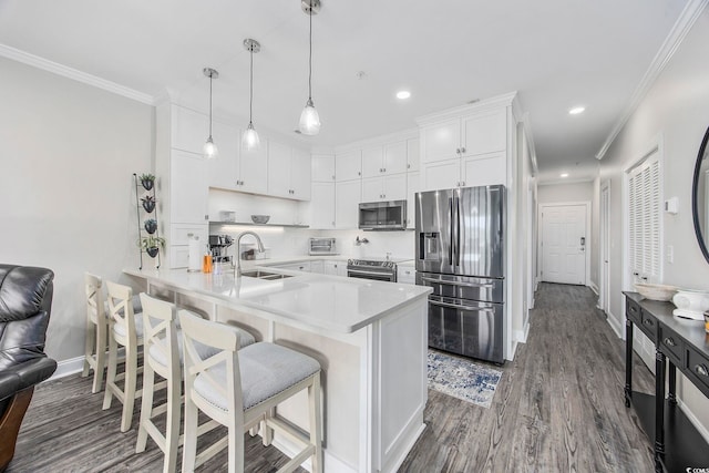 kitchen with stainless steel appliances, sink, white cabinets, dark hardwood / wood-style flooring, and kitchen peninsula