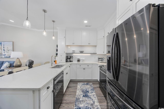 kitchen with appliances with stainless steel finishes, dark hardwood / wood-style floors, sink, kitchen peninsula, and hanging light fixtures