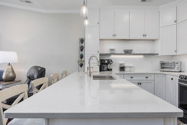 kitchen featuring sink, decorative backsplash, and white cabinetry