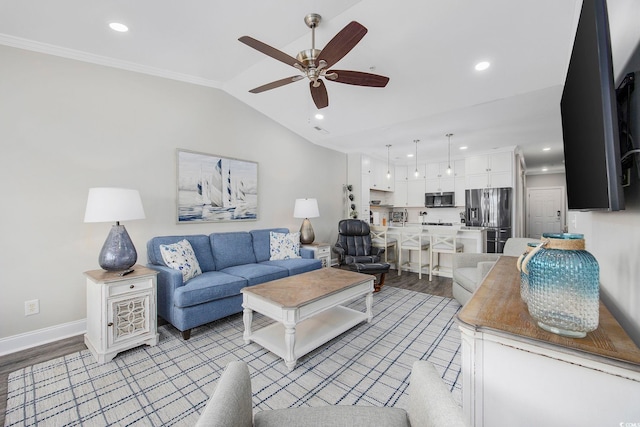 living room featuring ceiling fan, crown molding, and light hardwood / wood-style flooring