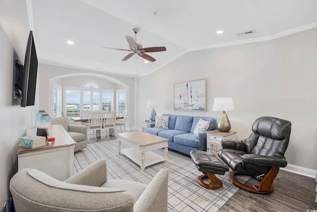 living room with ceiling fan, ornamental molding, vaulted ceiling, and light wood-type flooring