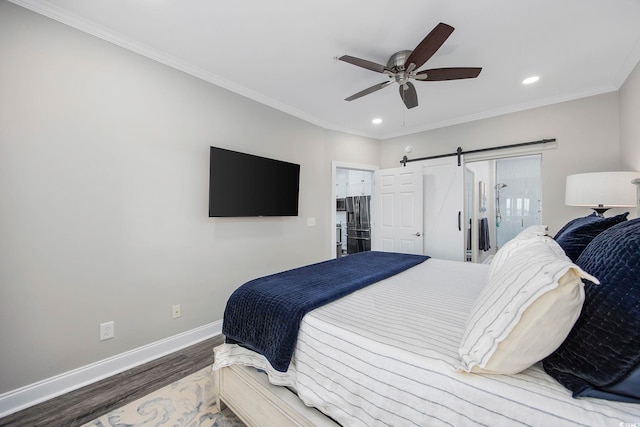 bedroom featuring ceiling fan, ornamental molding, hardwood / wood-style flooring, and a barn door