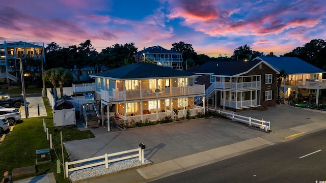 back house at dusk with a balcony