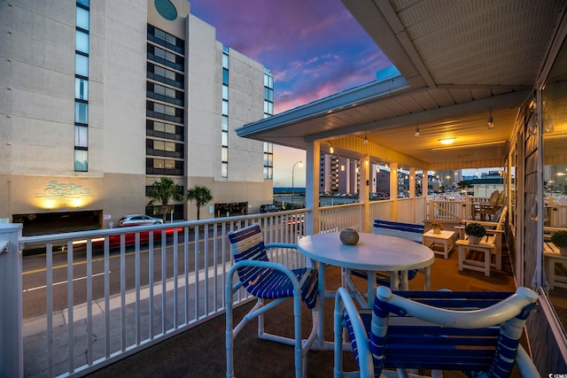 view of balcony at dusk