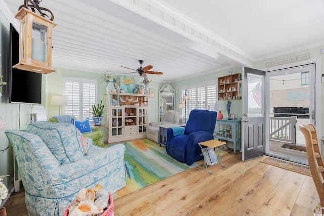 interior space featuring crown molding, hardwood / wood-style flooring, ceiling fan, and a wealth of natural light