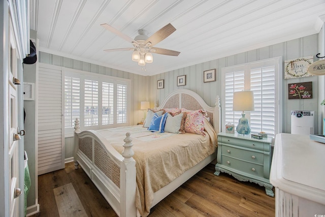 bedroom featuring dark hardwood / wood-style flooring, crown molding, and ceiling fan