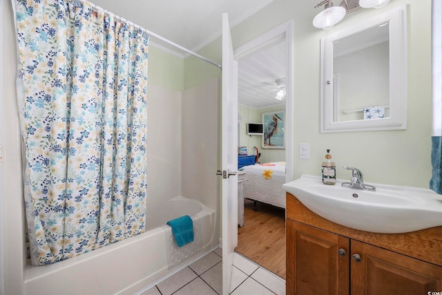 bathroom featuring vanity, ceiling fan, shower / tub combo, and tile patterned flooring