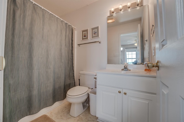 bathroom with toilet, curtained shower, and vanity