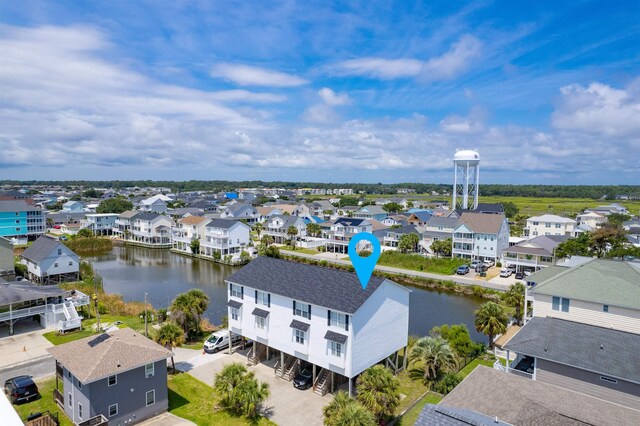 drone / aerial view featuring a water view and a residential view