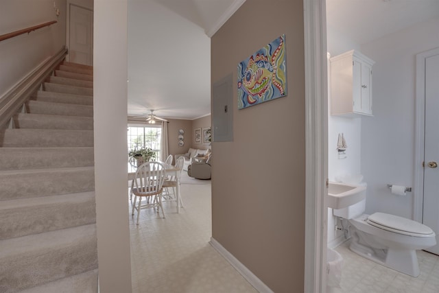 hallway featuring baseboards, crown molding, stairway, and tile patterned floors