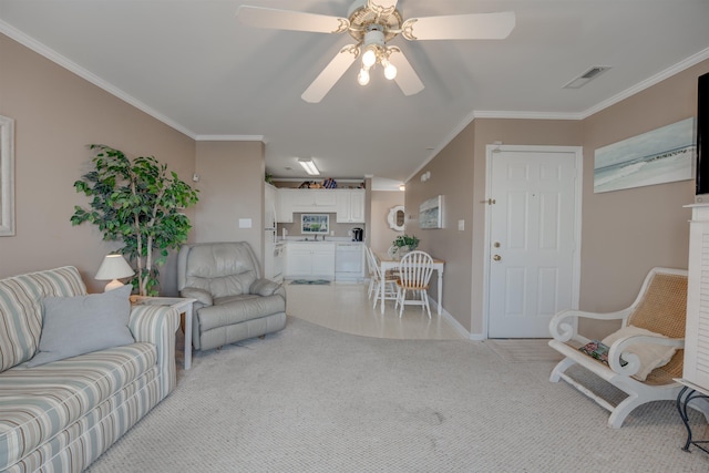 living area with light carpet, ceiling fan, visible vents, and crown molding