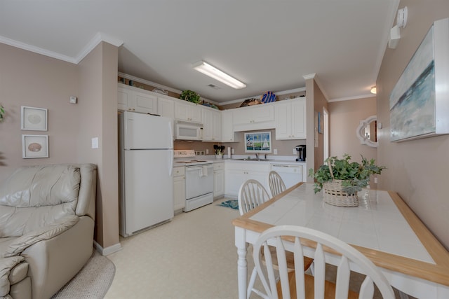 kitchen featuring white cabinetry, sink, tile countertops, white appliances, and light carpet