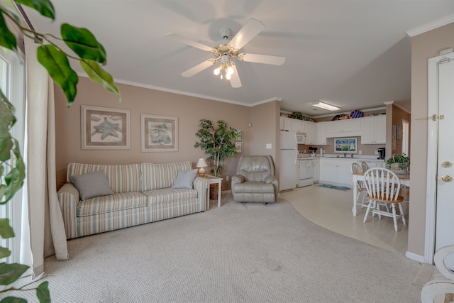 unfurnished living room featuring ceiling fan, crown molding, and light carpet