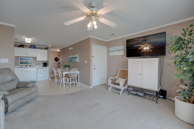 living room with sink, ceiling fan, ornamental molding, and light colored carpet