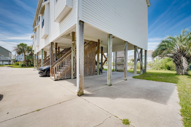 view of patio / terrace with a carport, stairway, and concrete driveway