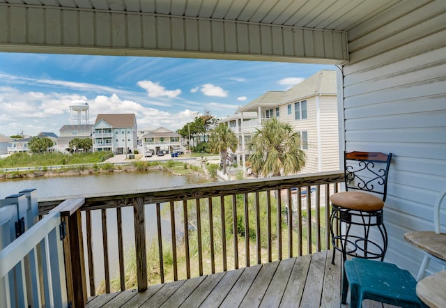 deck with a water view and a residential view