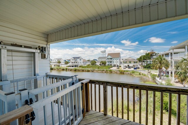 exterior space featuring a balcony and a water view