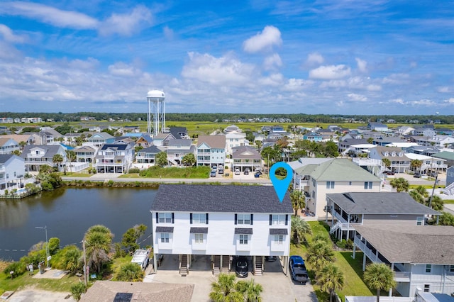 drone / aerial view featuring a water view and a residential view