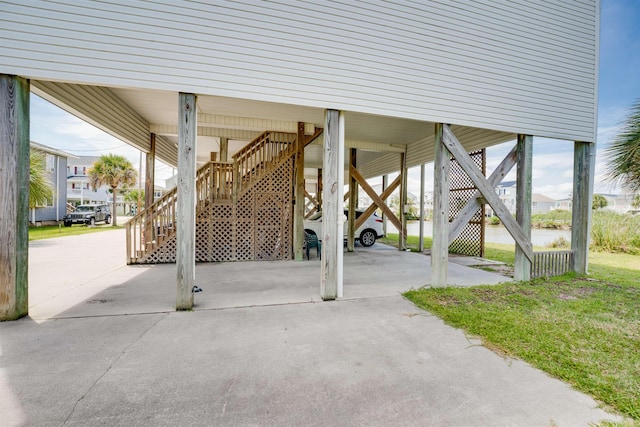 view of patio / terrace with stairs and a carport