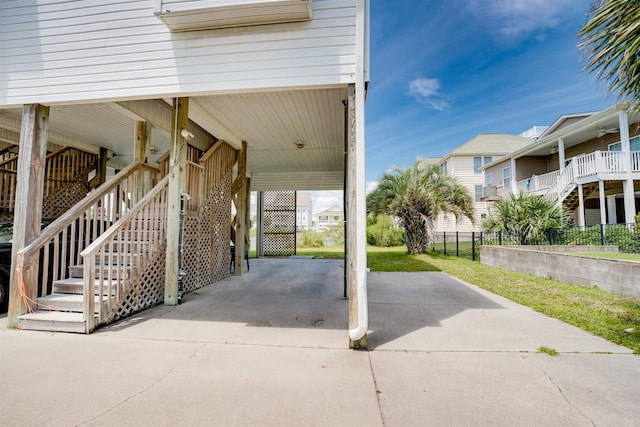 view of patio / terrace featuring a carport, stairway, and concrete driveway