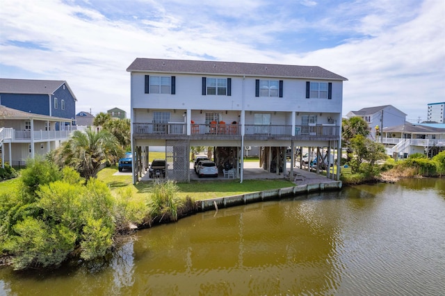 rear view of property with a water view