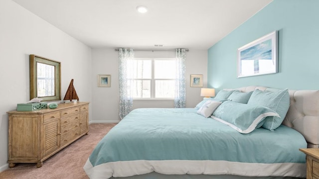 bedroom featuring light carpet