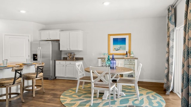 dining space with dark hardwood / wood-style flooring