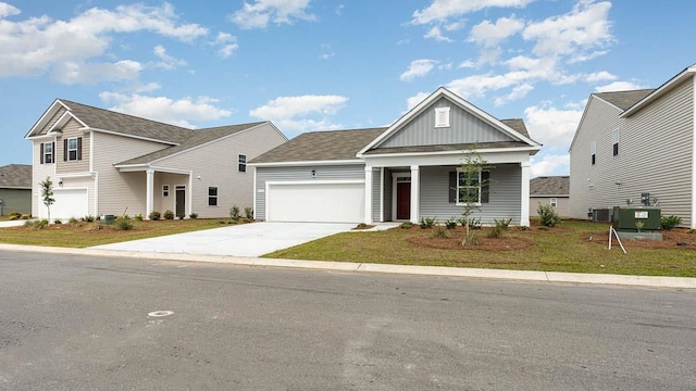 view of front of home with a garage, a porch, and central air condition unit