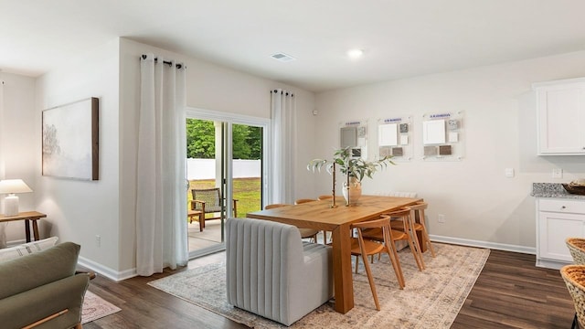 dining room with radiator and dark hardwood / wood-style flooring