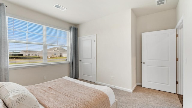 bedroom with light colored carpet