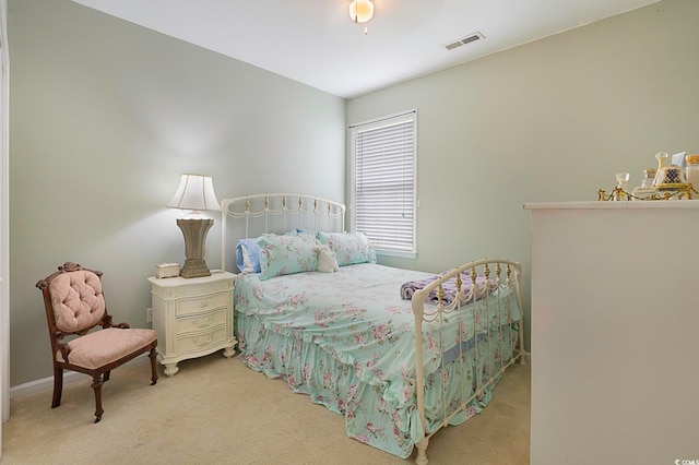 bedroom featuring light carpet