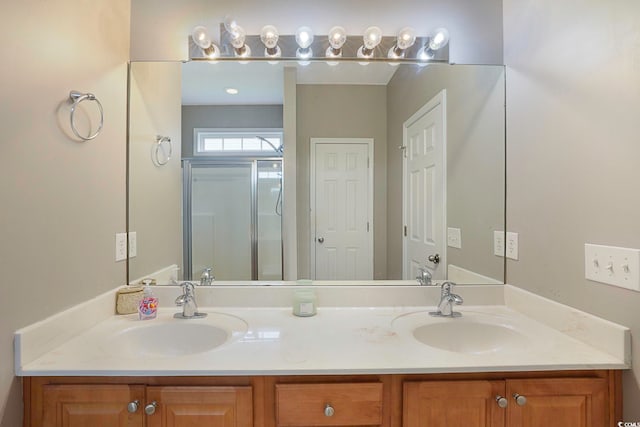 bathroom featuring vanity and an enclosed shower