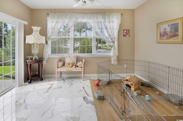 interior space with ceiling fan