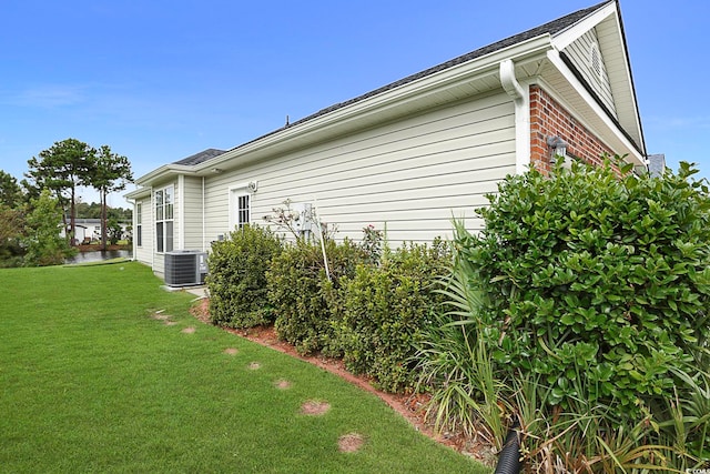 view of home's exterior featuring central AC and a lawn