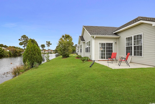 view of yard with a patio area and a water view