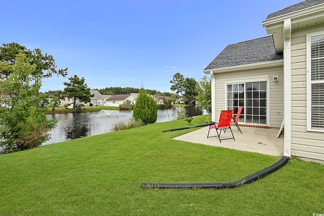 view of yard featuring a patio and a water view