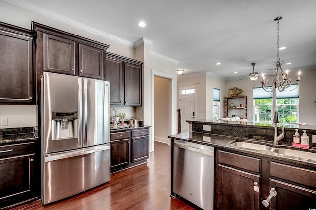 1348 Peterson St, Myrtle Beach, SC 29577 - kitchen featuring appliances with stainless steel finishes, a sink, dark brown cabinetry, dark wood-style flooring, and dark stone counters